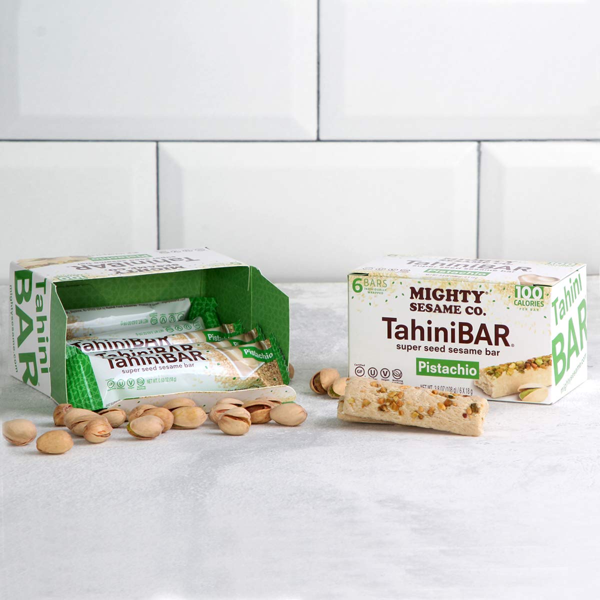 Mighty Sesame TahiniBars box open with six wrappers for on-the-go snacking.