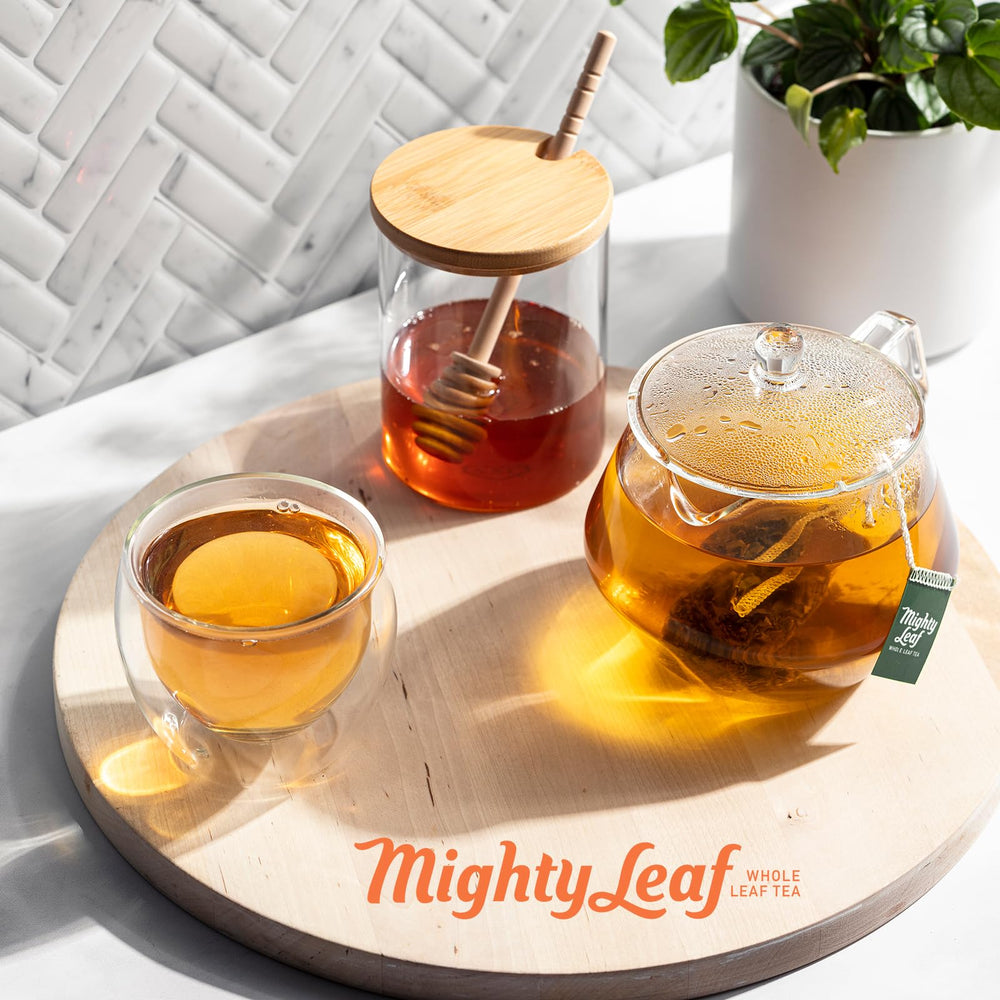 Mighty Leaf Chamomile Citrus tea cup emitting calming fragrance at dusk.
