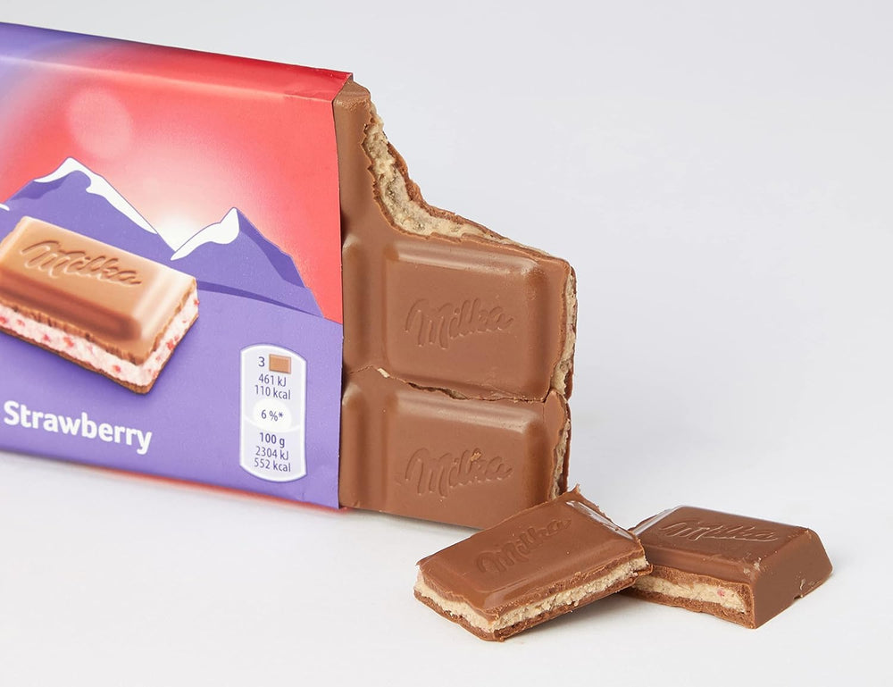Milka Strawberry Yoghurt Chocolate cross-section reveals creamy yoghurt filling, ideal for a treat.