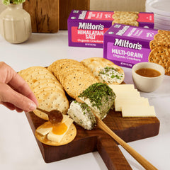 Charcuterie board featuring Milton's Crackers with meats and spreads