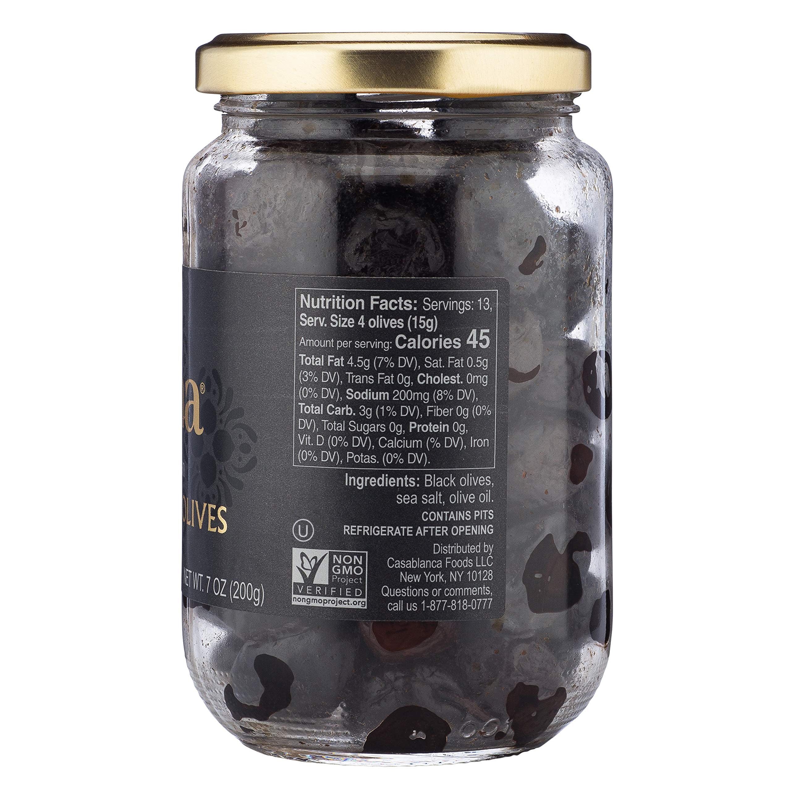Mina dry cured black olives in jar shown in kitchen setting for fresh taste