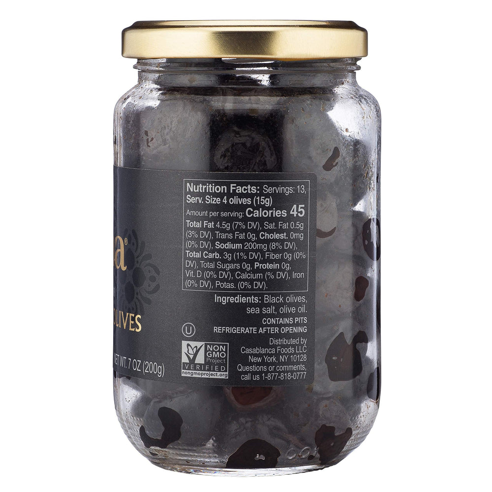 Mina dry cured black olives in jar shown in kitchen setting for fresh taste