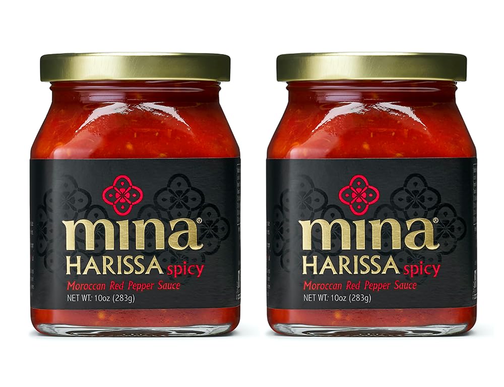 Mina Harissa hot sauce bottle with vibrant red color ready to elevate dishes.
