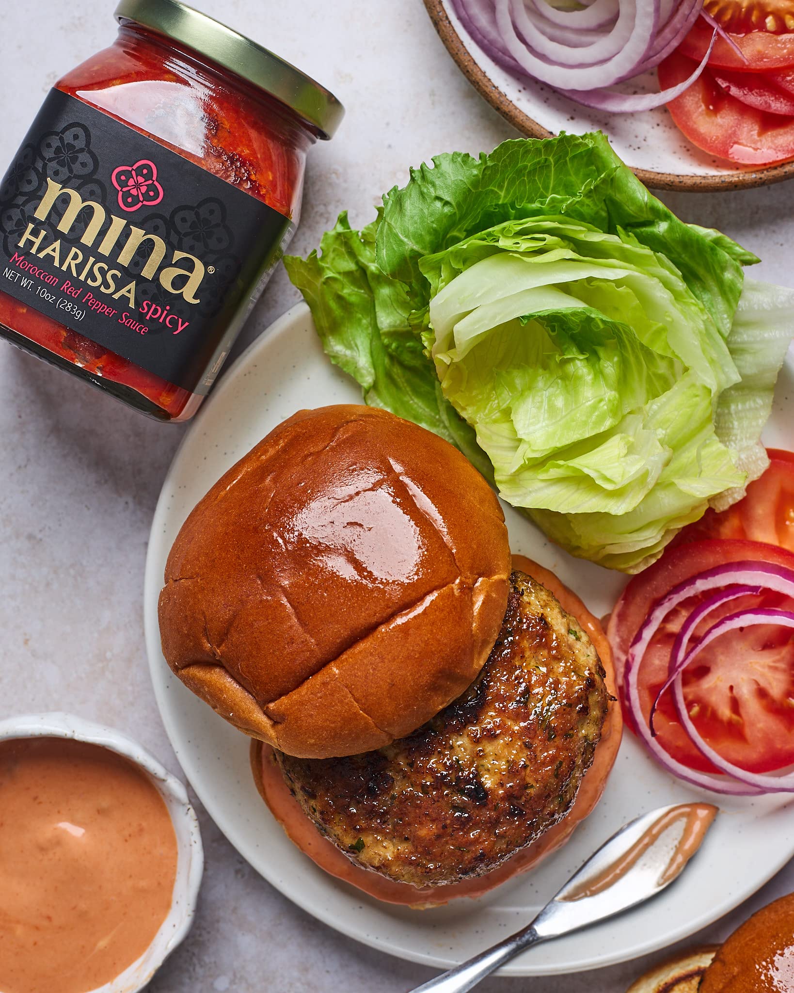 Mina Harissa sauce on eggs demonstrates breakfast versatility and tangy kick.