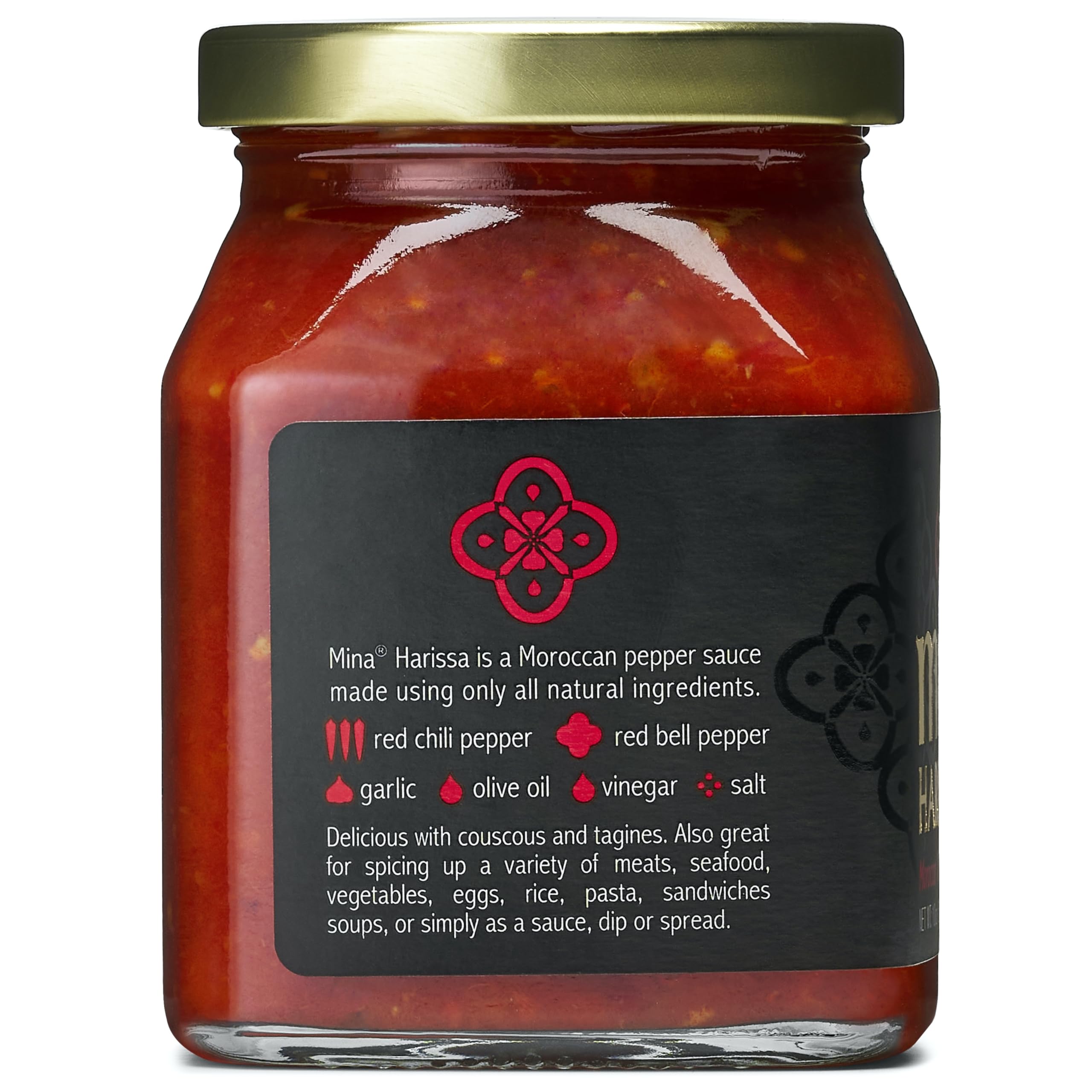Mina Harissa bottle beside pizza shows its use as sauce or marinade.
