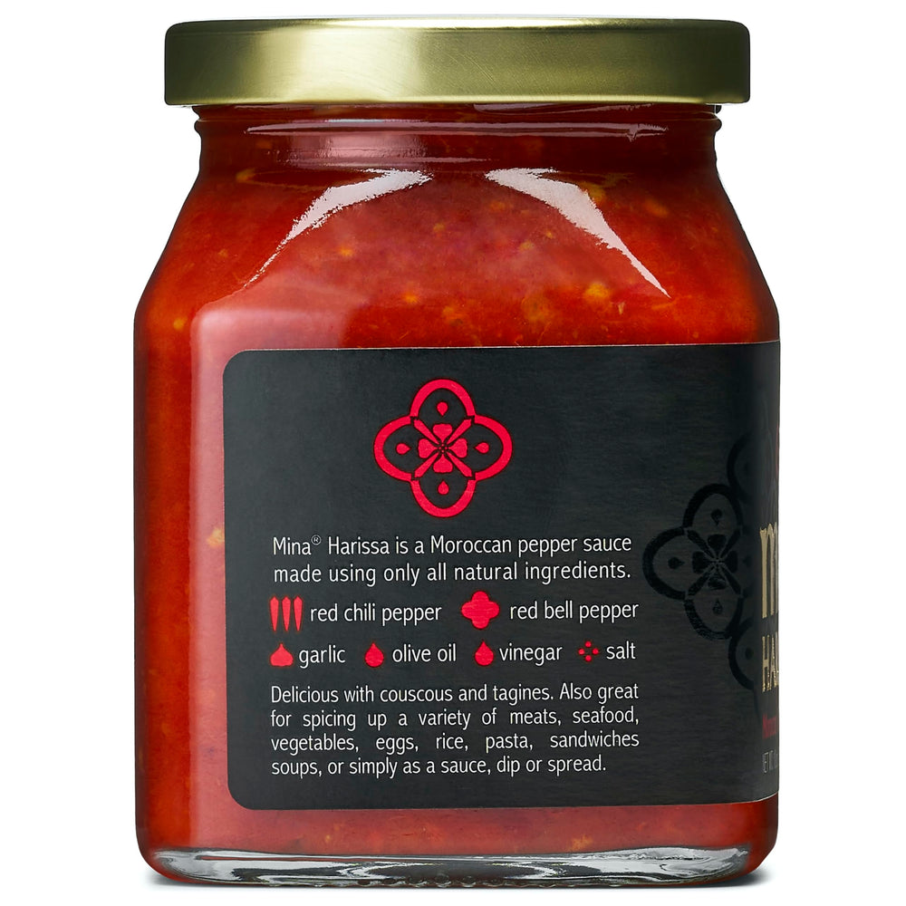 Mina Harissa bottle beside pizza shows its use as sauce or marinade.