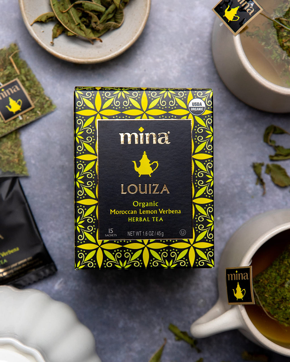 Mina Louiza biodegradable sachets organized for convenient hot or iced tea preparation.