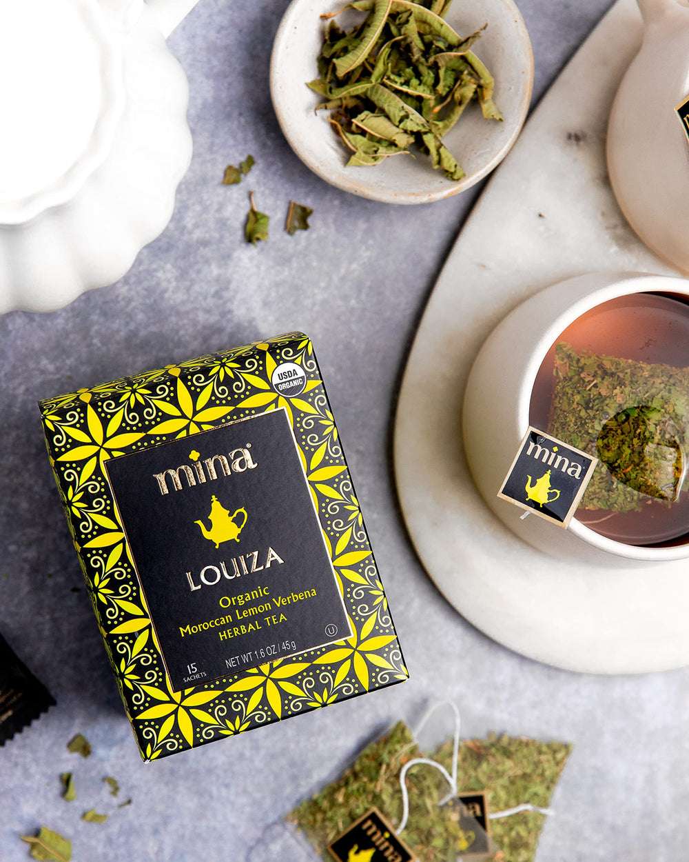 Mina Louiza lemon verbena tea steeping in glass evokes a refreshing afternoon ritual.