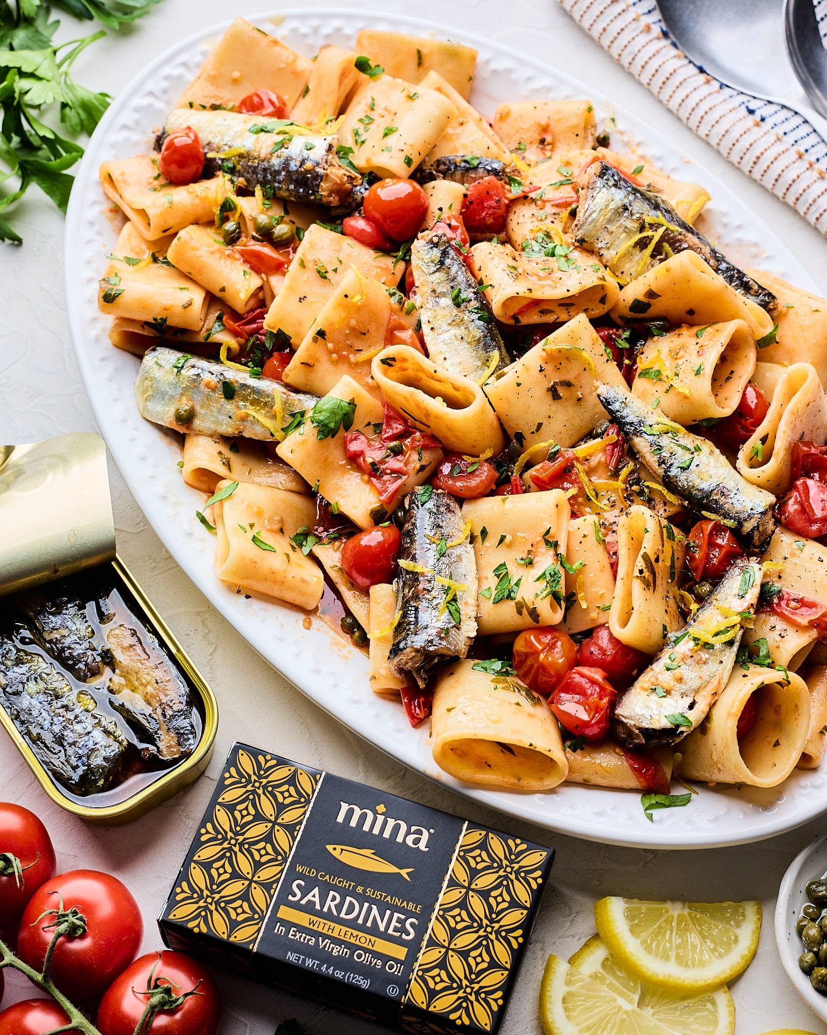 Mina Sardines with lemon on pasta enhances flavor and color.