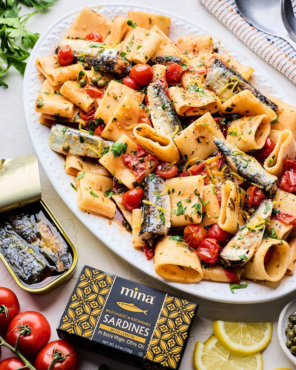 Mina Sardines with lemon on pasta enhances flavor and color.