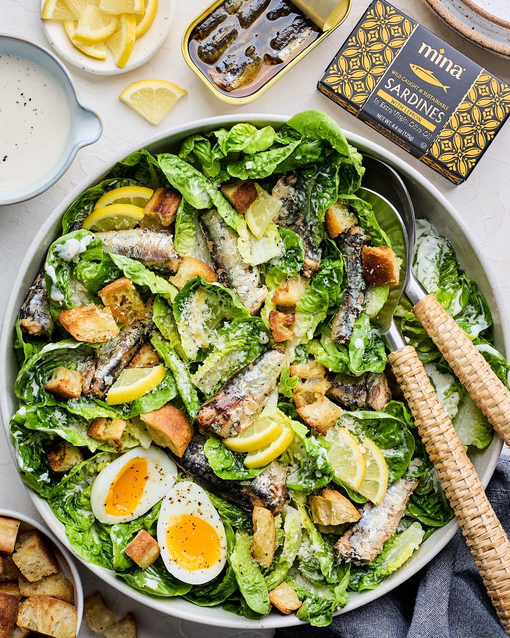 Mina Sardines plated with lemon for a bright, versatile dish.