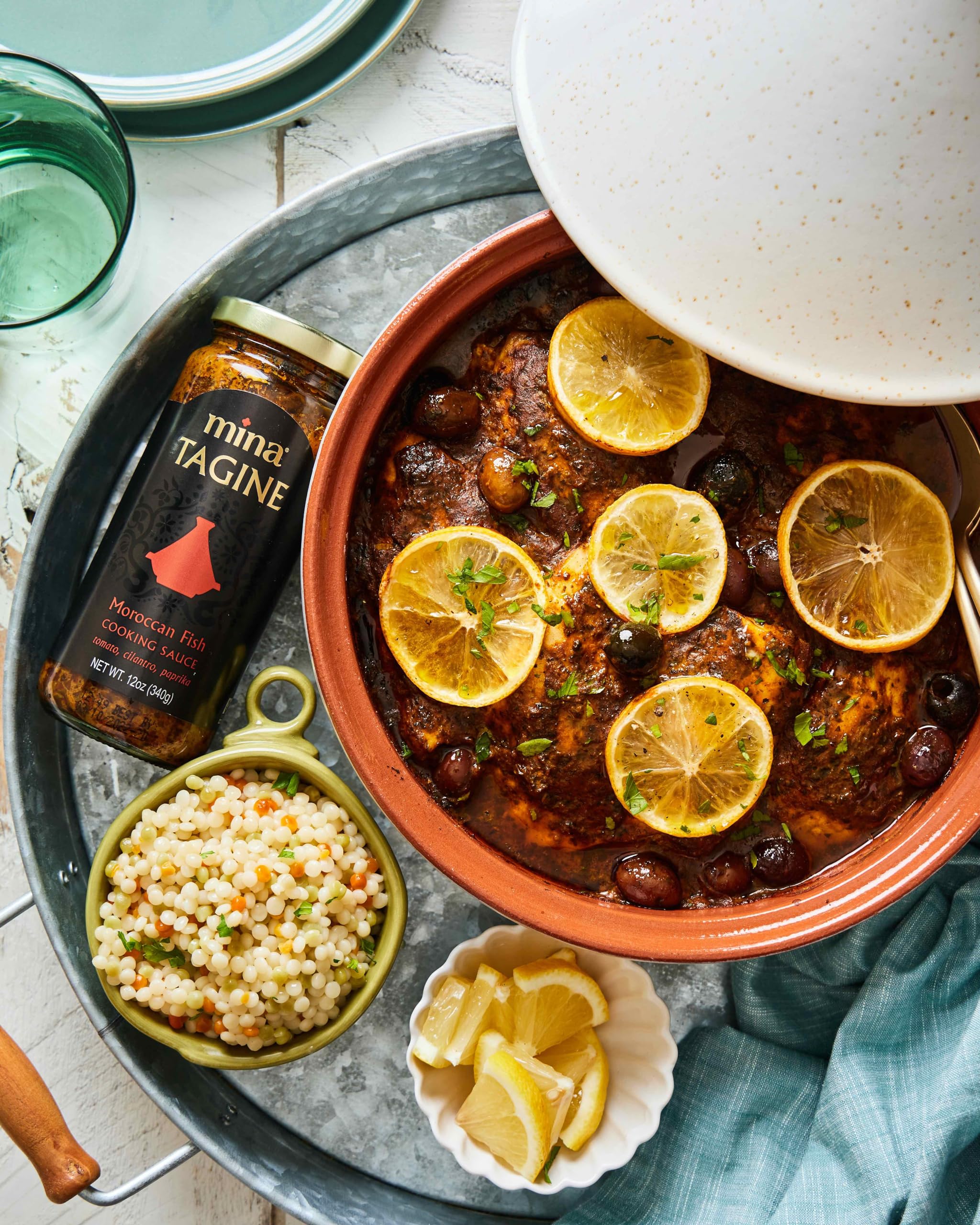 Mina Tagine Fish simmer sauce plated with couscous and vegetables.