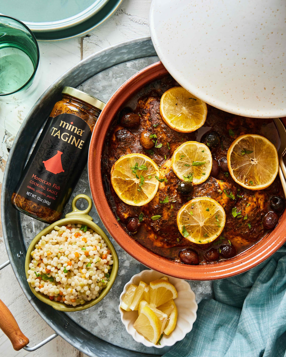 Mina Tagine Fish simmer sauce plated with couscous and vegetables.