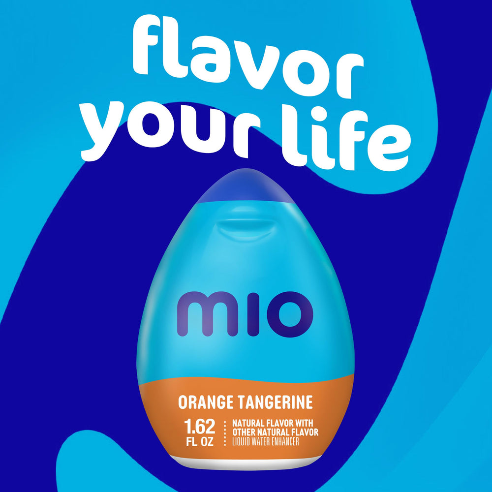 Mio Orange Tangerine bottle beside purse for convenient travel hydration
