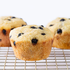 Miss Jones Baking blueberry muffins closeup showing moist crumb and real fruit, perfect snack.