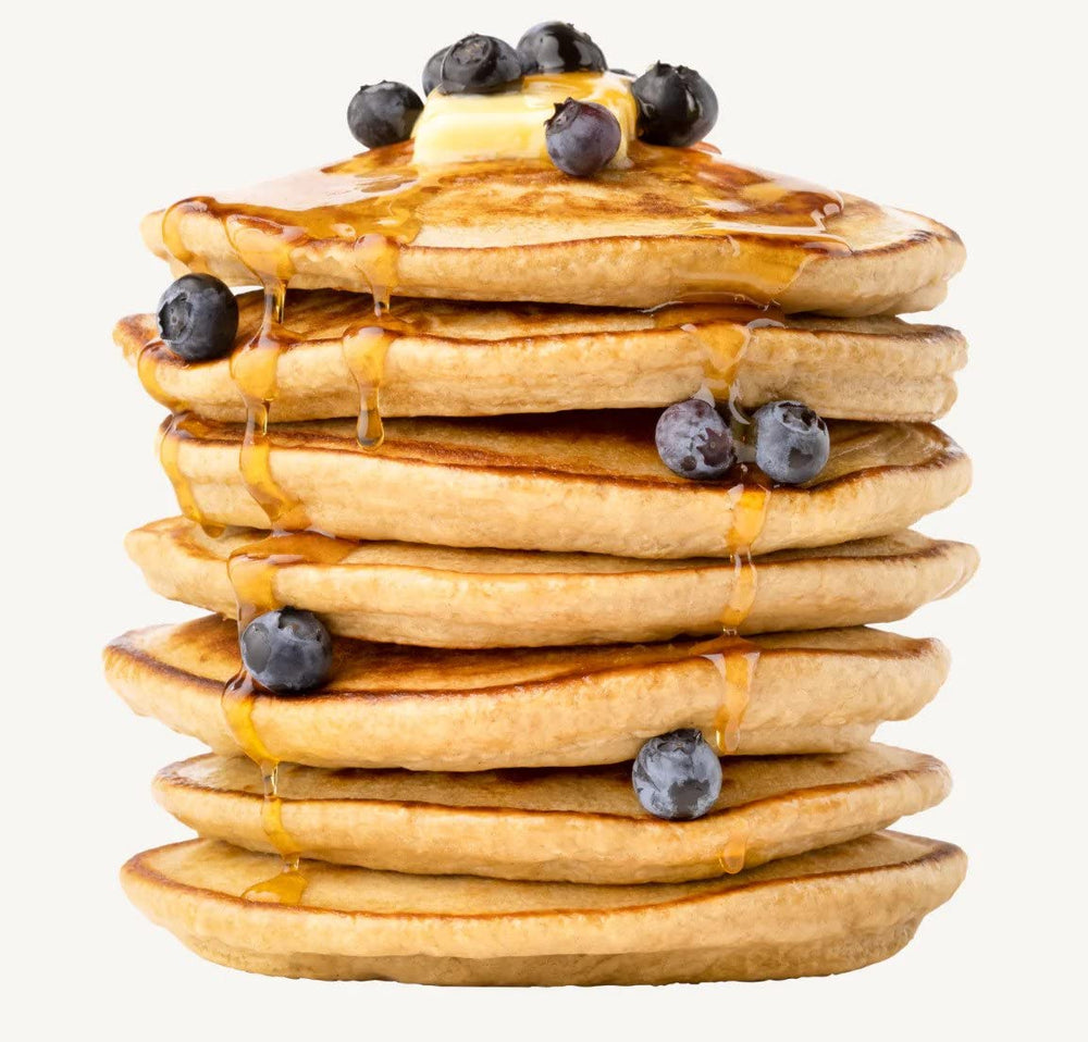 Miss Jones Baking Oat Pancake Mix fluffy pancakes stacked with syrup and berries
