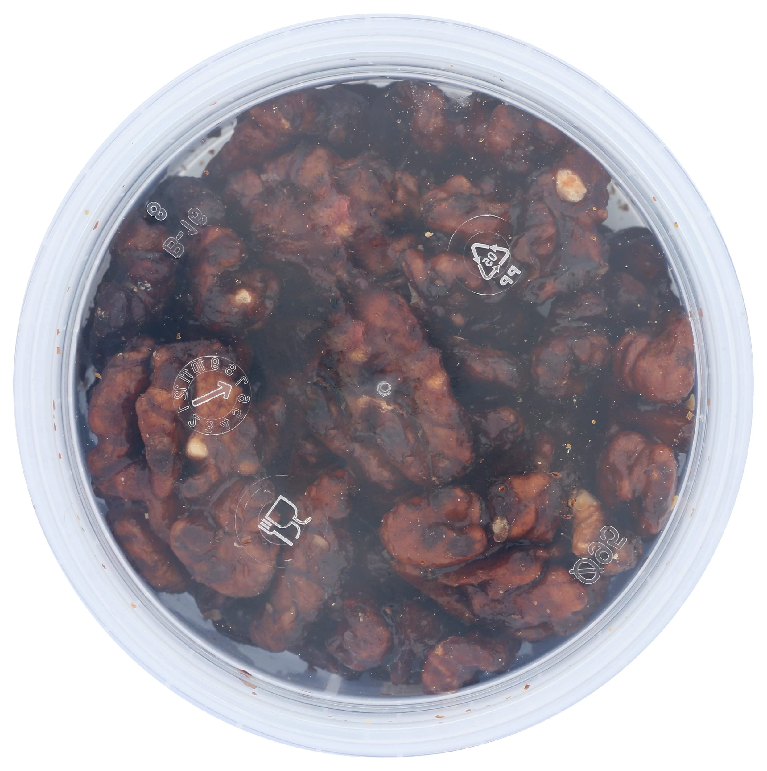 Close-up of Mitica caramelized walnuts with a gleaming glaze and rich color.