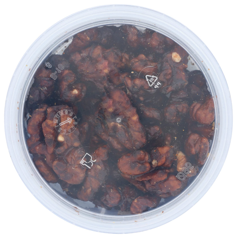 Close-up of Mitica caramelized walnuts with a gleaming glaze and rich color.