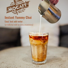 MOCAFÉ chai latte glass with steam demonstrates luxurious, ready-to-drink indulgence at home.