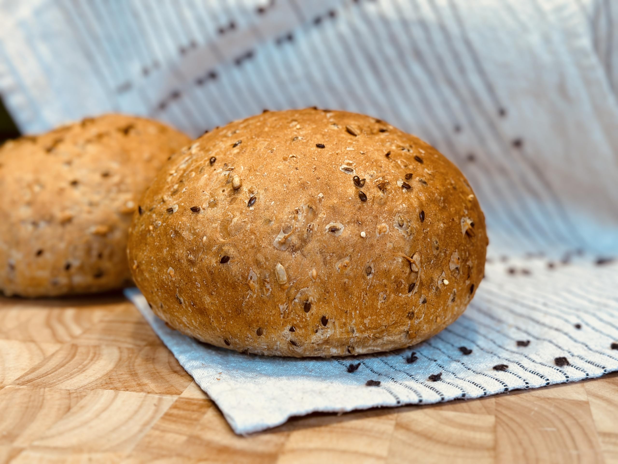 Molibake 8 Grain Bread Mix seeds closeup highlights flax, sesame, and millet texture.