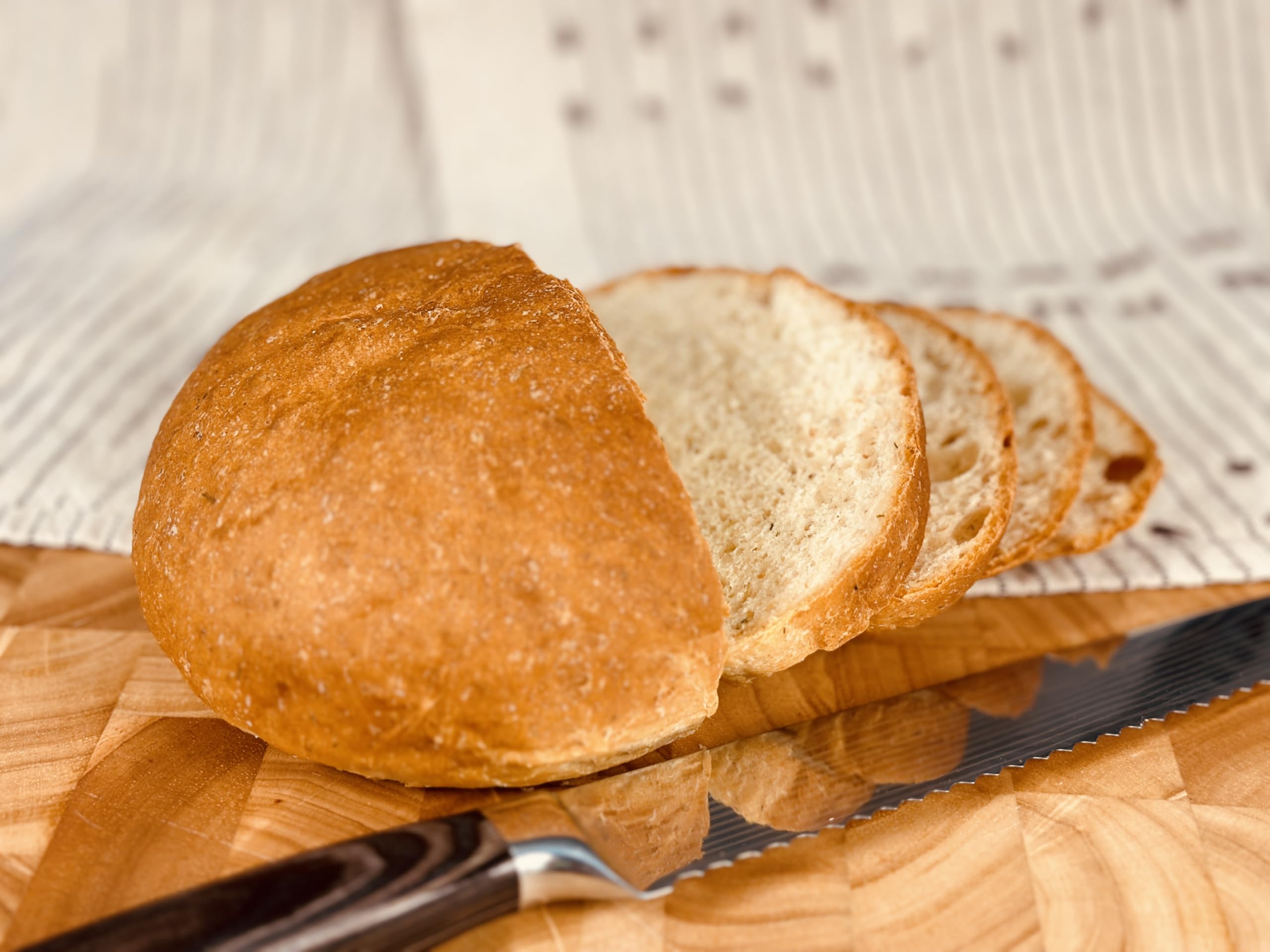 Sliced Molibake potato bread served with butter and herbs
