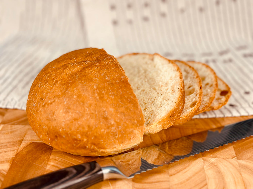 Sliced Molibake potato bread served with butter and herbs