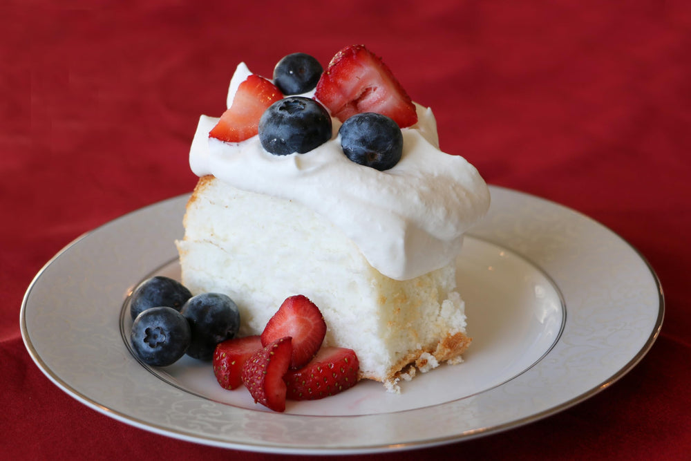 A slice of baked Mom's Place gluten-free angel food cake with delicate crumb