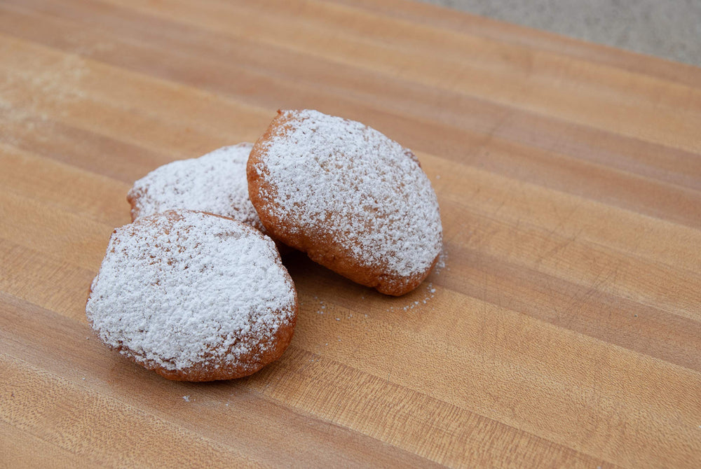 Beignets dusted with sugar, ready for brunch or dessert with Mom's Place