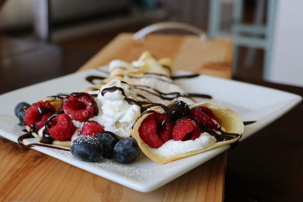 Mom's Place Gluten-Free crepes plated with fruit, versatile breakfast or dessert.