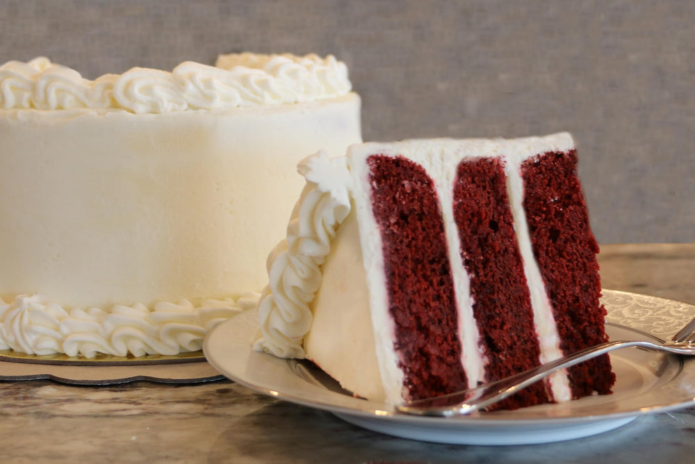 A baked red velvet cake slice from Mom's Place, moist and indulgent.