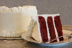 A baked red velvet cake slice from Mom's Place, moist and indulgent.