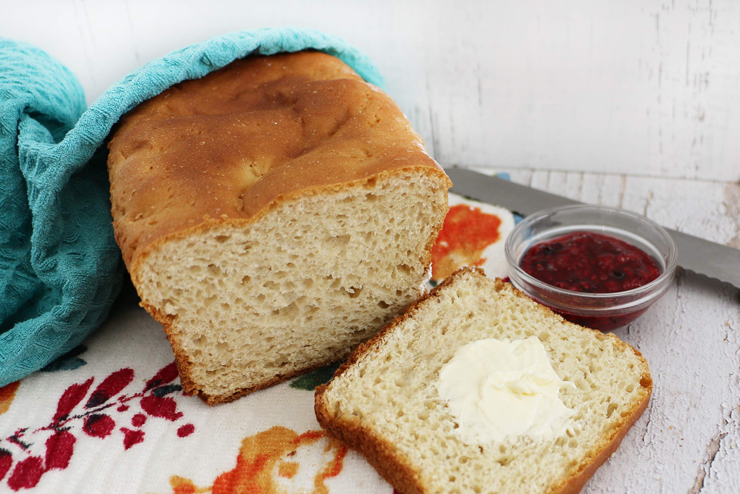 Fresh gluten-free rolls bake in oven from Mom's Place mix with golden crust.