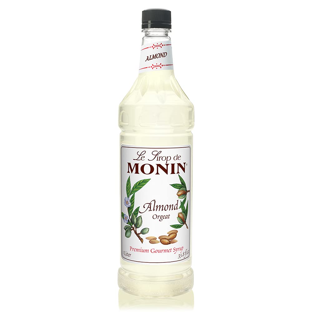Monin Almond Syrup bottle pour with rich nutty notes for coffee