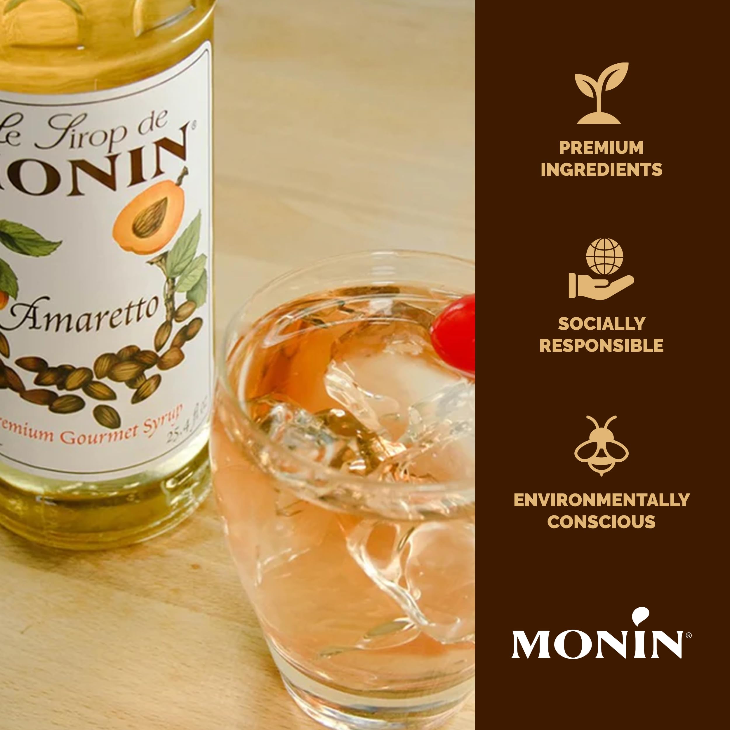 Monin Amaretto Syrup bottle beside a cocktail glass, elevating cocktails.