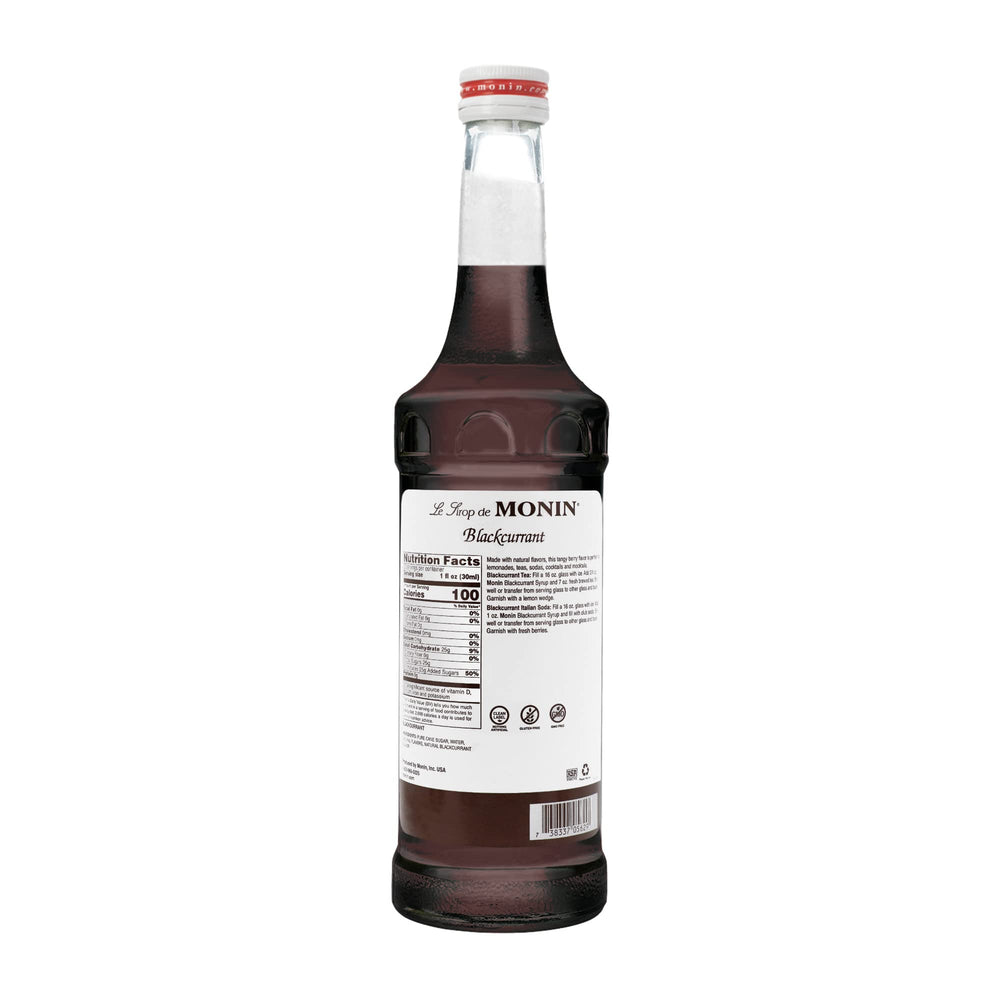 A glass with Monin Blackcurrant Syrup creating a rich, fruity drink.