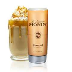 Monin Gourmet Caramel Sauce bottle pouring, ideal for desserts and coffee enhancement