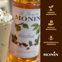 Glass of latte with Monin Hazelnut Syrup and creamy foam.