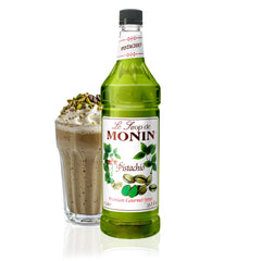 Monin Pistachio Syrup bottle pouring to add rich pistachio flavor to coffee