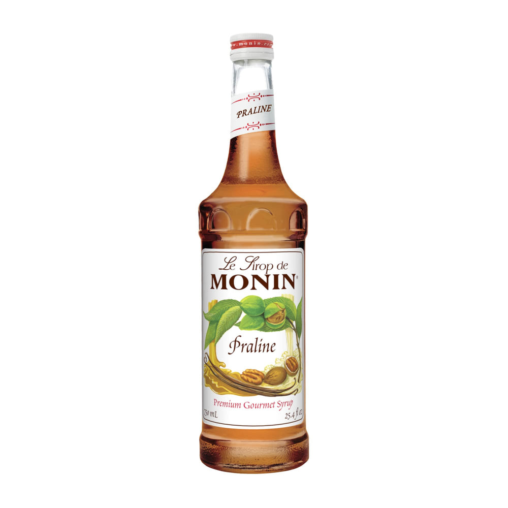 Monin Praline Syrup bottle pouring into a latte with rich praline aroma.