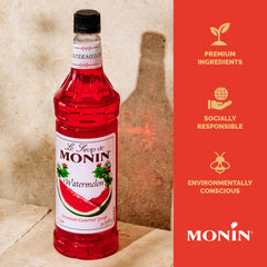Monin raspberry syrup bottle close-up highlighting fruity tartness for cocktails.