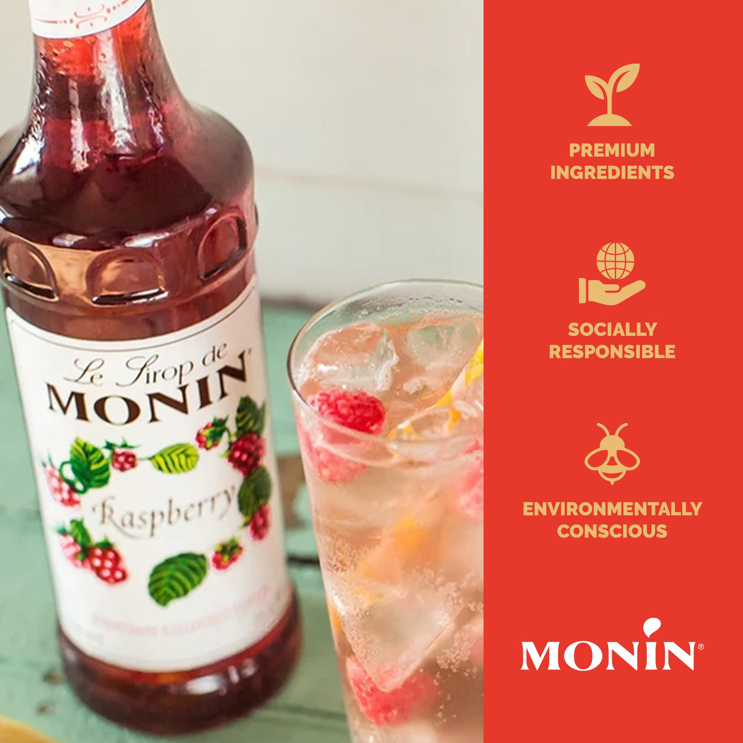 Monin Raspberry Syrup being poured over a refreshing soda.