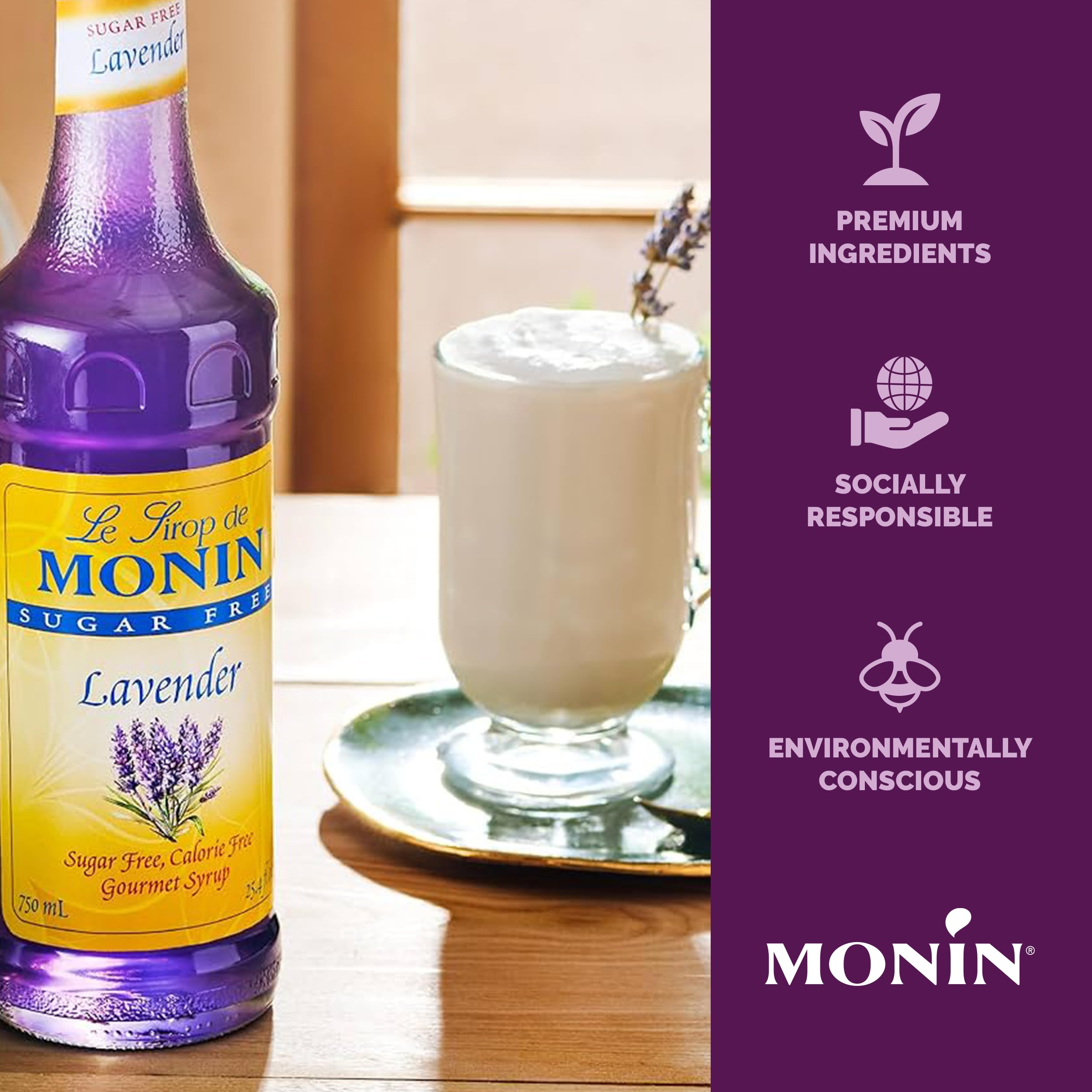 Monin Lavender Syrup bottle beside a refreshing cocktail.