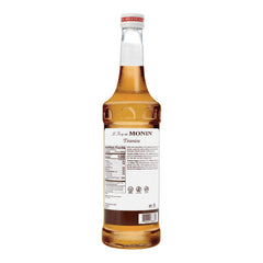 Monin Tiramisu Syrup being poured, ideal for coffee or dessert cocktails.