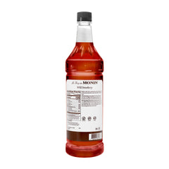 Monin Wild Strawberry Syrup pour delivers vibrant strawberry flavor for smoothies and cocktails.
