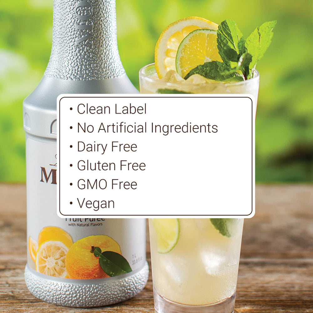 Monin Yuzu Purée bottle pouring over a glass with citrus slices.