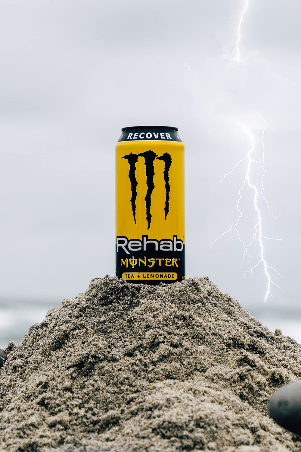 Monster Rehab Tea Lemonade on a supermarket shelf indicates a non-carbonated energy option.