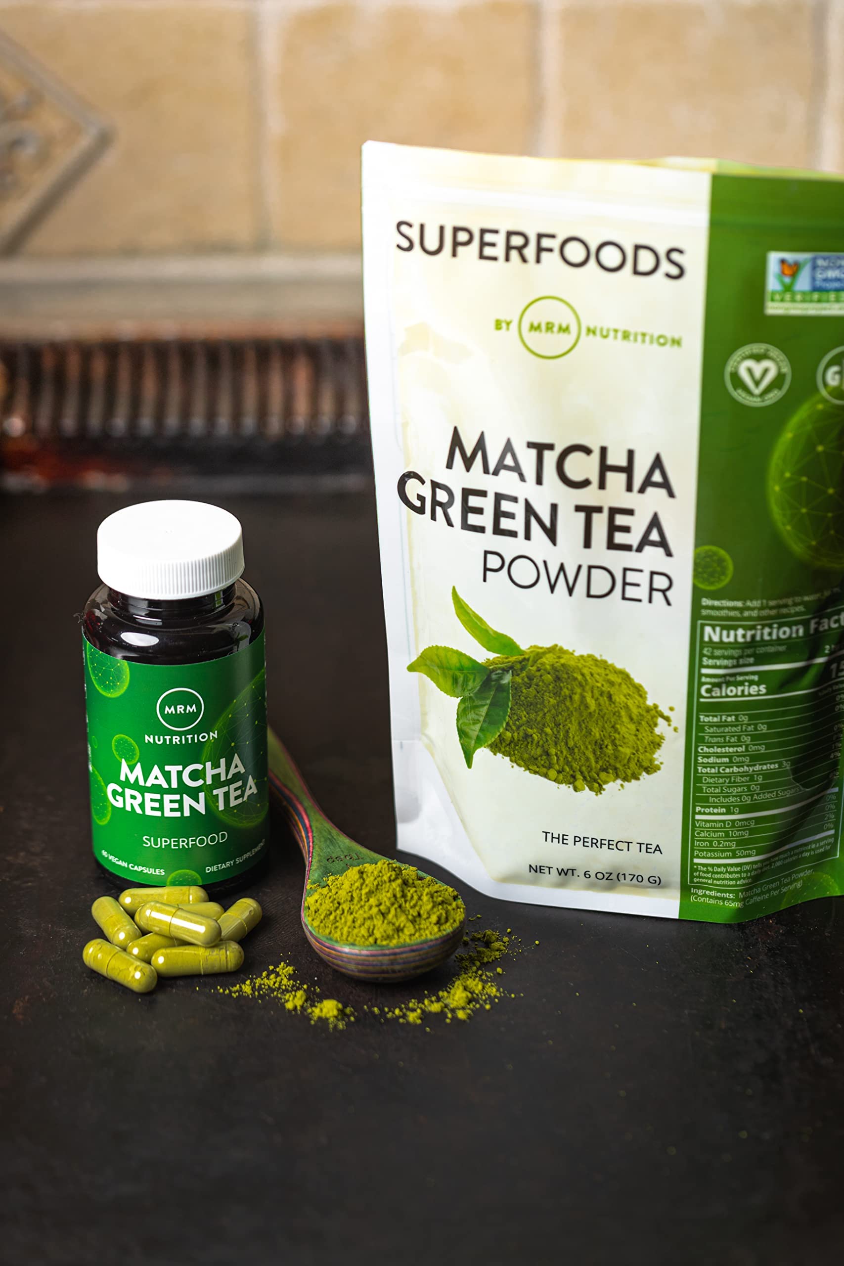 MRM Matcha Green Tea Powder scoop ready for precise measuring in drinks or baking.
