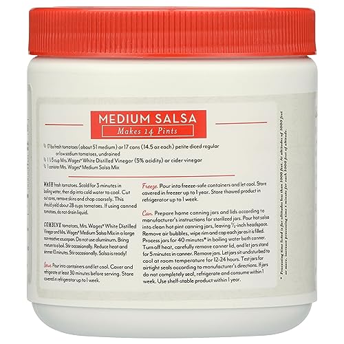 Mrs. Wages Salsa Canning Mix stirred with tomatoes for customizable salsa.