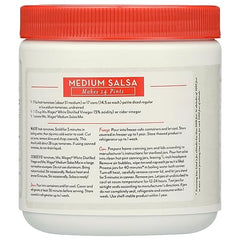 Mrs. Wages Salsa Canning Mix stirred with tomatoes for customizable salsa.