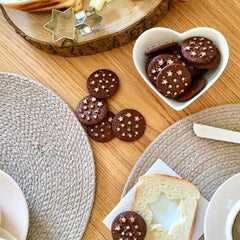 Mulino Bianco Pan di Stelle biscuits dipping in milk, perfect snack.